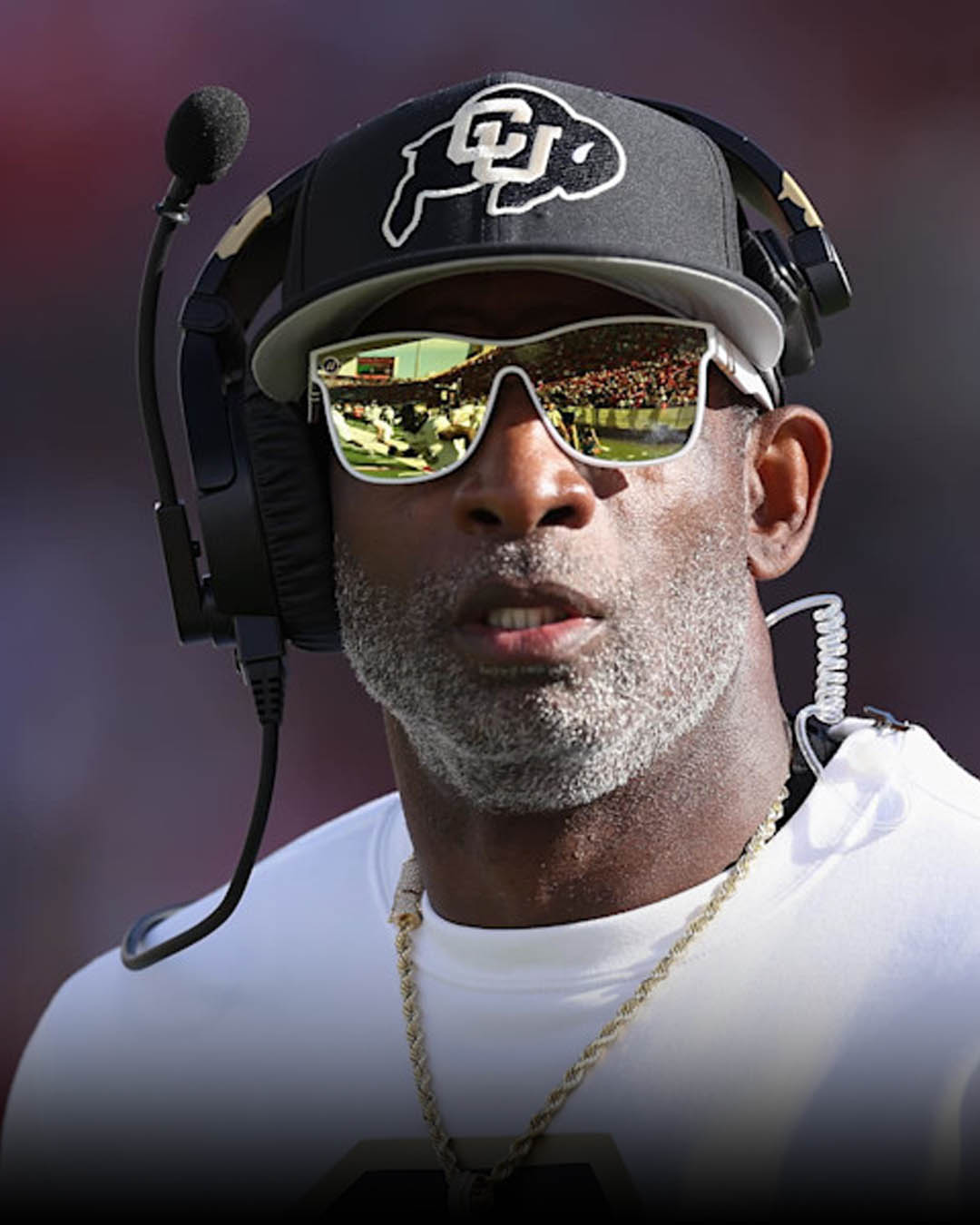 Colorado Buffaloes Head Coach Deion "Coach Prime" Sanders speaking at spring practice, alongside defensive backs Carter Stoutmire and RJ Johnson.