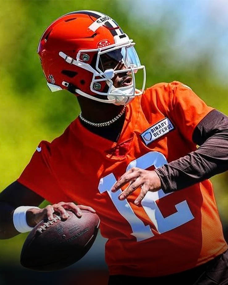 Shedeur Sanders throws a pass during Cleveland Browns rookie mini camp, wearing a white helmet and practice jersey, representing the Colorado Buffaloes in the NFL.