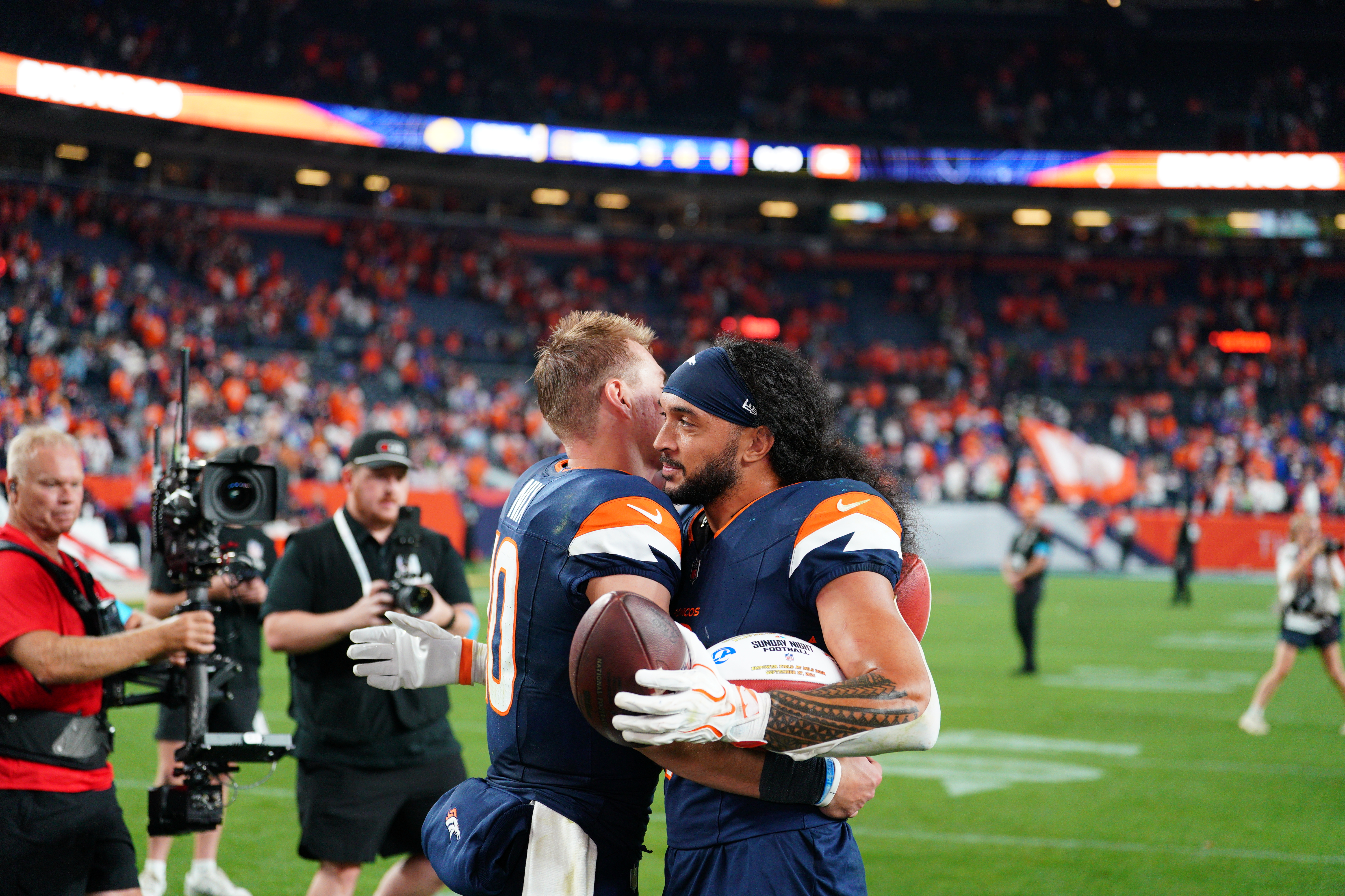 Denver Broncos safety Talanoa Hufanga returns an interception against the Los Angeles Rams during the Broncos’ 30-26 comeback win on Sunday Night Football at Empower Field at Mile High.